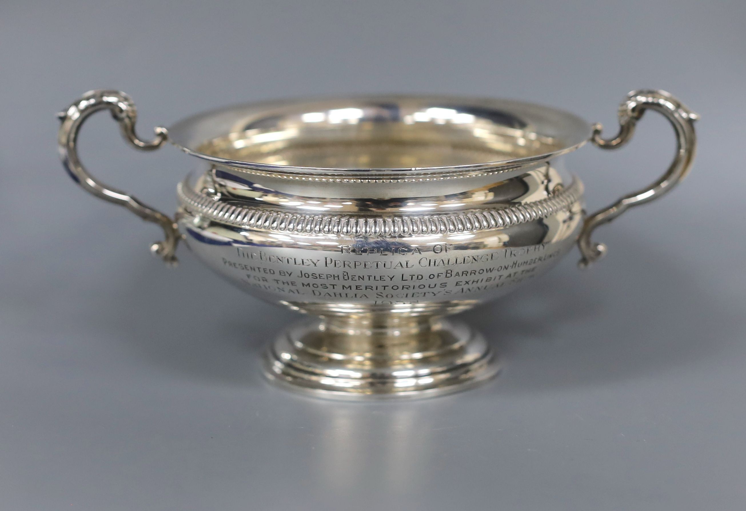 A George V silver small rose bowl, Birmingham, 1913, diameter 12.8cm and a later silver two handled bowl, gross 14.5oz.